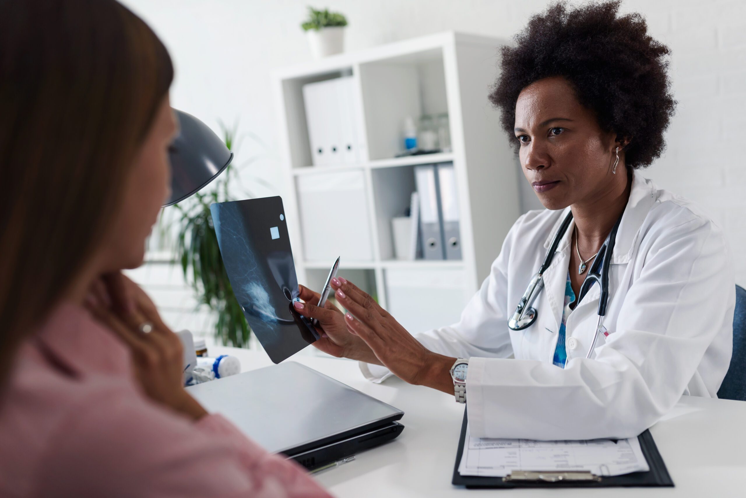 A female doctor sits at her desk and talks to a female patient w Extreme Sports Bike